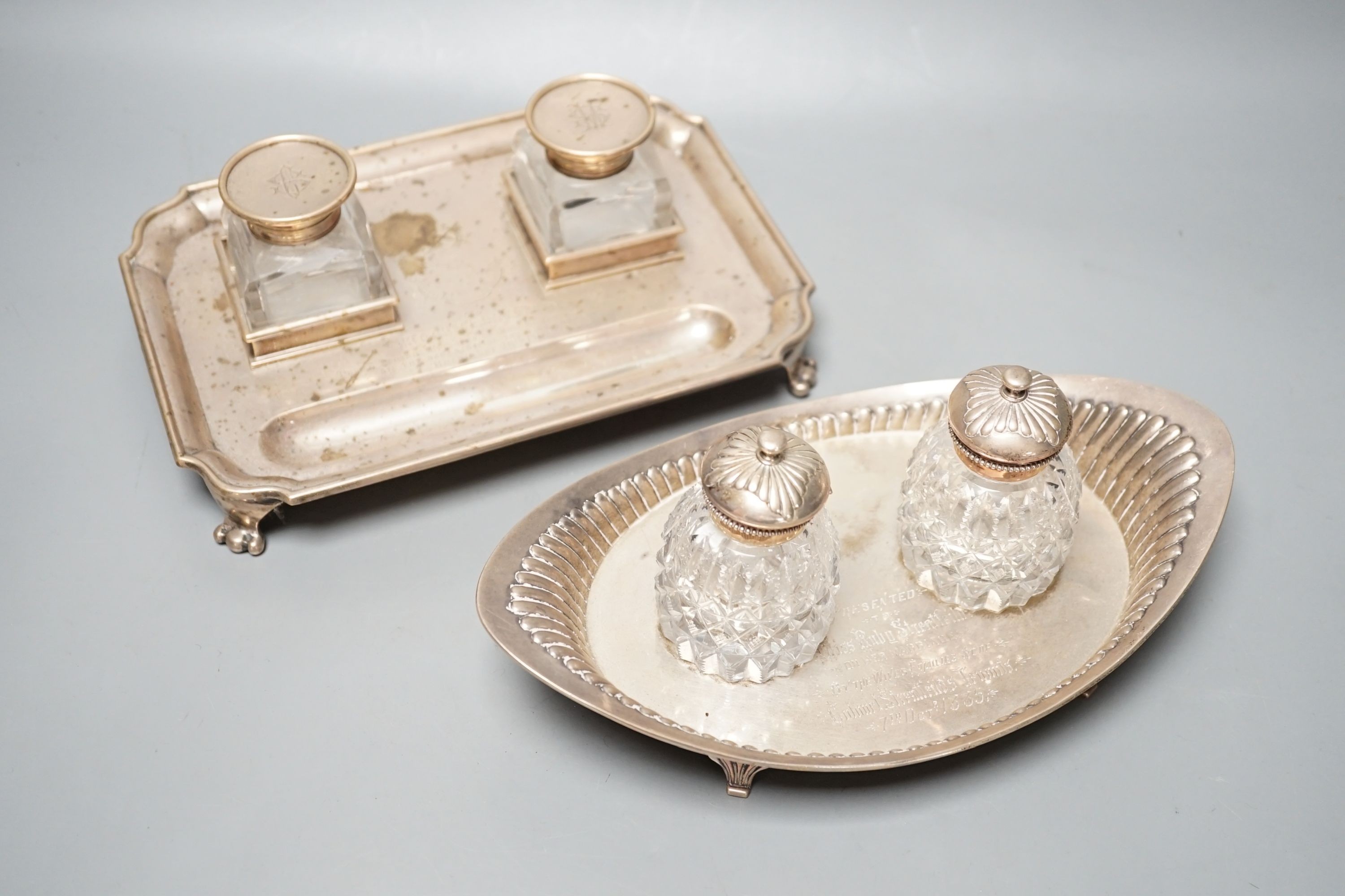 A presentation silver oval inkstand, with two mounted glass wells, William & John Barnard, London, 1884, ‘presented to Miss Ruby Streatfeild’, (a.f.),24.1cm and one other silver inkstand, Charles Stuart Harris, London, 1